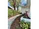 Landscaped walkway leading to the home's entrance, framed by lush plants and trees at 10632 Whitestone Ct, Orlando, FL 32817