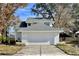 Charming home featuring an attached two-car garage, green lawn, and beautiful landscaping at 10632 Whitestone Ct, Orlando, FL 32817