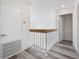 Second floor hallway with modern railings, lighting, and luxury vinyl plank flooring at 10632 Whitestone Ct, Orlando, FL 32817