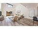 Bright, open living room with vaulted ceilings, wood-look flooring, and large windows at 10632 Whitestone Ct, Orlando, FL 32817