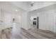 Open-concept living area with wood-look flooring, white walls, and easy access to kitchen at 10632 Whitestone Ct, Orlando, FL 32817