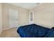 Simple bedroom with blue comforter and carpet flooring at 11237 Amber Ridge Dr, Zellwood, FL 32798