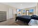 Primary bedroom with a king-size bed and large windows at 11237 Amber Ridge Dr, Zellwood, FL 32798