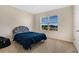 Bedroom with gray headboard, blue bedding, and a window view at 11237 Amber Ridge Dr, Zellwood, FL 32798