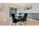 Breakfast nook with glass table and four dark chairs at 11237 Amber Ridge Dr, Zellwood, FL 32798
