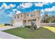 Two story house with landscaping and a driveway at 11237 Amber Ridge Dr, Zellwood, FL 32798