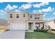 Two-story house with a green door and a white garage door at 11237 Amber Ridge Dr, Zellwood, FL 32798