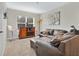 Game room with brown leather sectional sofa and a floor lamp at 11237 Amber Ridge Dr, Zellwood, FL 32798