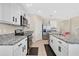 Kitchen with granite countertops, stainless steel appliances and white cabinets at 11237 Amber Ridge Dr, Zellwood, FL 32798