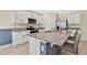White kitchen cabinets, granite island, stainless steel appliances at 11237 Amber Ridge Dr, Zellwood, FL 32798