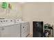 Laundry room with washer, dryer, and extra shelving at 11237 Amber Ridge Dr, Zellwood, FL 32798