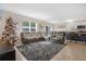 Spacious living room with gray sectional sofa and a Christmas tree at 11237 Amber Ridge Dr, Zellwood, FL 32798