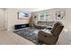 Living room with gray sectional sofa and electric fireplace at 11237 Amber Ridge Dr, Zellwood, FL 32798