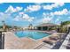 Community pool with lounge chairs and shaded seating area at 11237 Amber Ridge Dr, Zellwood, FL 32798