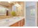 Double vanity bathroom with wood cabinets and a view of a bedroom at 1610 Conway Isle Cir, Belle Isle, FL 32809