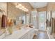 Bathroom with white vanity, toilet and shower with access to backyard at 1610 Conway Isle Cir, Belle Isle, FL 32809
