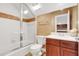 Small bathroom with shower, toilet and wood vanity at 1610 Conway Isle Cir, Belle Isle, FL 32809