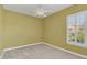 Charming bedroom with neutral walls and a window with shutters at 1610 Conway Isle Cir, Belle Isle, FL 32809