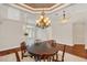 Formal dining room featuring hardwood floors and a stunning chandelier at 1610 Conway Isle Cir, Belle Isle, FL 32809