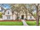 House with a stone walkway and manicured lawn at 1610 Conway Isle Cir, Belle Isle, FL 32809