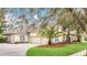 Home with a three-car garage and palm trees at 1610 Conway Isle Cir, Belle Isle, FL 32809