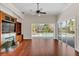 Gathering room with hardwood floors, fireplace, and sliding doors to the pool at 1610 Conway Isle Cir, Belle Isle, FL 32809