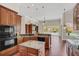 Eat-in kitchen with granite countertops and wood cabinets at 1610 Conway Isle Cir, Belle Isle, FL 32809