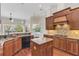 Island kitchen with granite counters and stainless steel appliances at 1610 Conway Isle Cir, Belle Isle, FL 32809