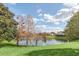 Peaceful lake view with lush greenery and mature trees at 1610 Conway Isle Cir, Belle Isle, FL 32809
