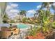 Relaxing pool area with patio furniture and lush landscaping at 1610 Conway Isle Cir, Belle Isle, FL 32809