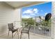 Private balcony with table and chairs offering a view of the parking lot at 3175 Feltrim Pl # 305, Kissimmee, FL 34747