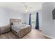 Bright bedroom with a queen bed and wood-like floors at 3175 Feltrim Pl # 305, Kissimmee, FL 34747