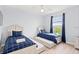 Bedroom with two twin beds, window, and ceiling fan at 3175 Feltrim Pl # 305, Kissimmee, FL 34747