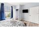 Bright bedroom with a queen bed and large window at 3175 Feltrim Pl # 305, Kissimmee, FL 34747