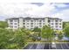 Three-story apartment building with ample parking and landscaping at 3175 Feltrim Pl # 305, Kissimmee, FL 34747