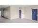 Apartment building hallway with neutral walls and blue apartment door at 3175 Feltrim Pl # 305, Kissimmee, FL 34747