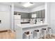 Modern kitchen with gray cabinets, white appliances, and breakfast bar with seating at 3175 Feltrim Pl # 305, Kissimmee, FL 34747
