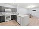Modern kitchen with gray cabinets and white appliances at 3175 Feltrim Pl # 305, Kissimmee, FL 34747