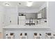 Modern kitchen with breakfast bar and gray cabinets at 3175 Feltrim Pl # 305, Kissimmee, FL 34747
