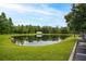 Serene pond with lush green landscaping at 3175 Feltrim Pl # 305, Kissimmee, FL 34747