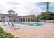 Community pool area with surrounding lounge chairs and building in background at 3175 Feltrim Pl # 305, Kissimmee, FL 34747