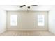 Bright bedroom with two windows and ceiling fan at 368 Pelham Park Dr, Deland, FL 32720