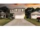 Two-story house with gray siding and a white garage door at 368 Pelham Park Dr, Deland, FL 32720