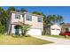 Two-story house with gray siding, white garage door, and blue shutters at 368 Pelham Park Dr, Deland, FL 32720