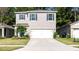 Two-story house with gray siding, white garage door, and blue shutters at 368 Pelham Park Dr, Deland, FL 32720