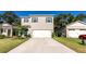 Two-story house with gray siding, white garage door, and blue shutters at 368 Pelham Park Dr, Deland, FL 32720