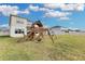Large grassy backyard with a playground set at 4360 Sunset Preserve Blvd, Orlando, FL 32820