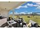 Covered patio with seating area overlooks a spacious backyard with playground at 4360 Sunset Preserve Blvd, Orlando, FL 32820