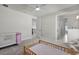 Spacious bedroom with a crib and daybed at 4360 Sunset Preserve Blvd, Orlando, FL 32820