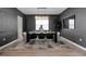 Elegant dining room with dark walls, chandelier, and modern table at 4360 Sunset Preserve Blvd, Orlando, FL 32820